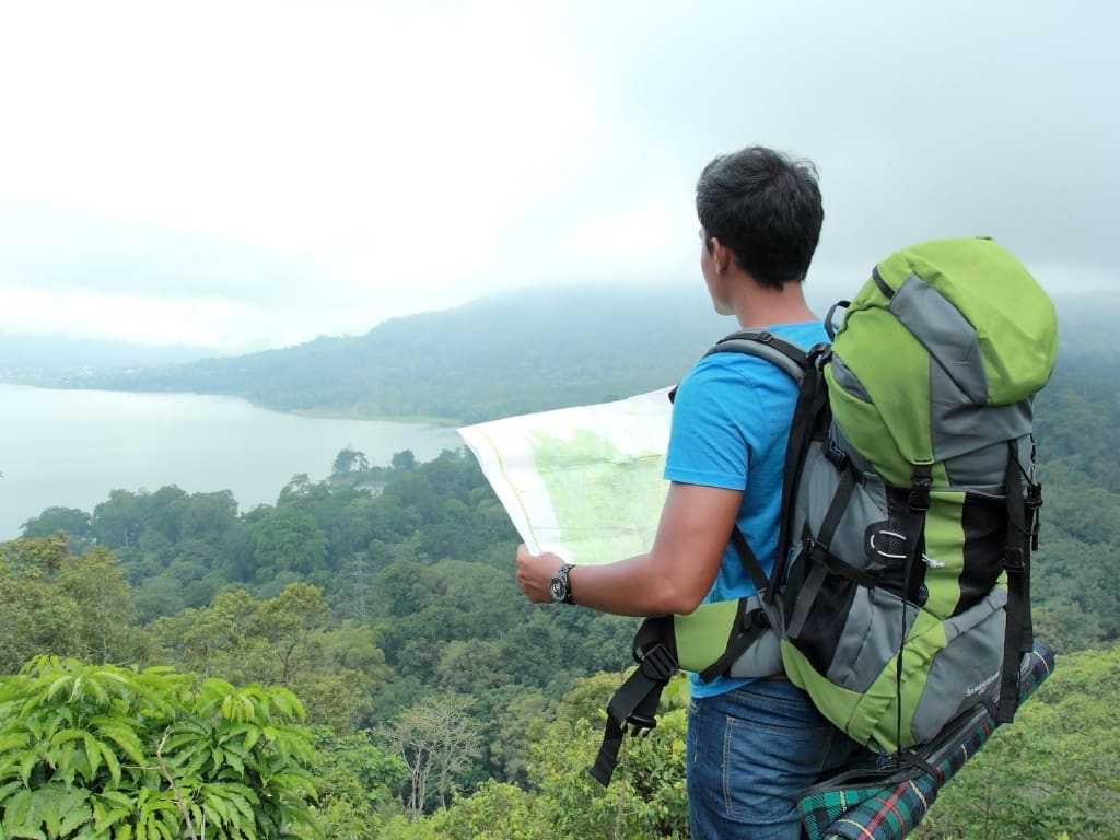 traveler with backpack and a map